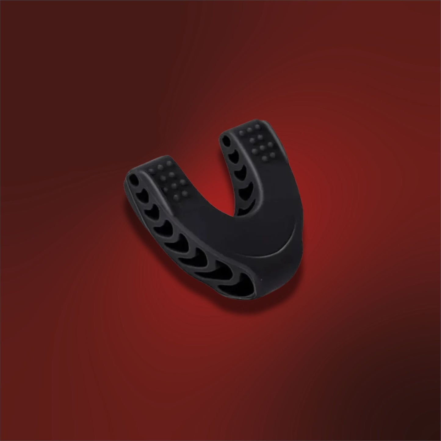 Black athletic mouthguard on a red background